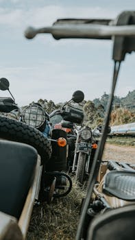 Vintage used broken motorcycles in different types placed in abandoned area for utilization