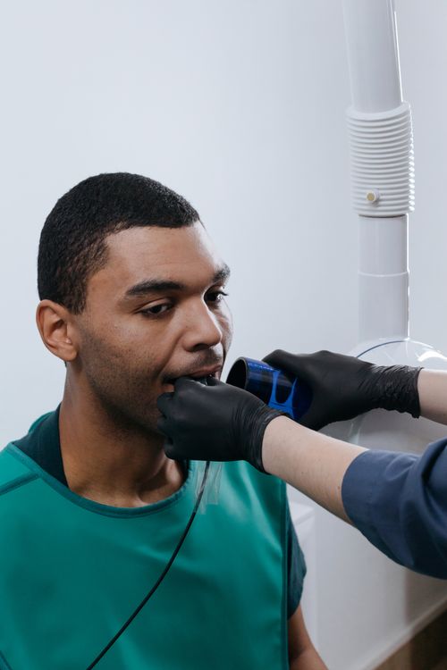 Free A patient undergoing a dental x-ray examination in a clinic setting. Stock Photo
