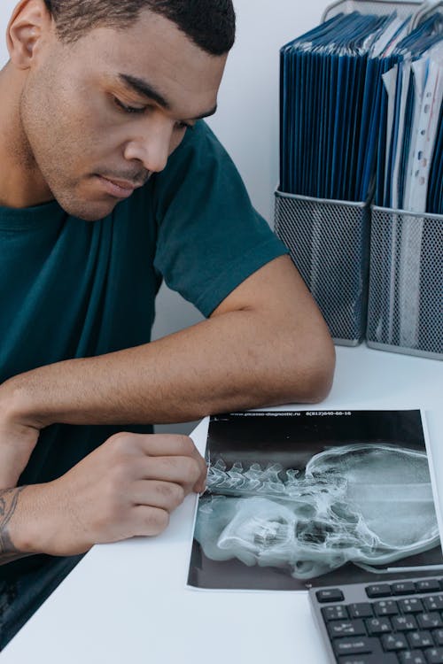 Free A Man Looking at an X-Ray Image Stock Photo