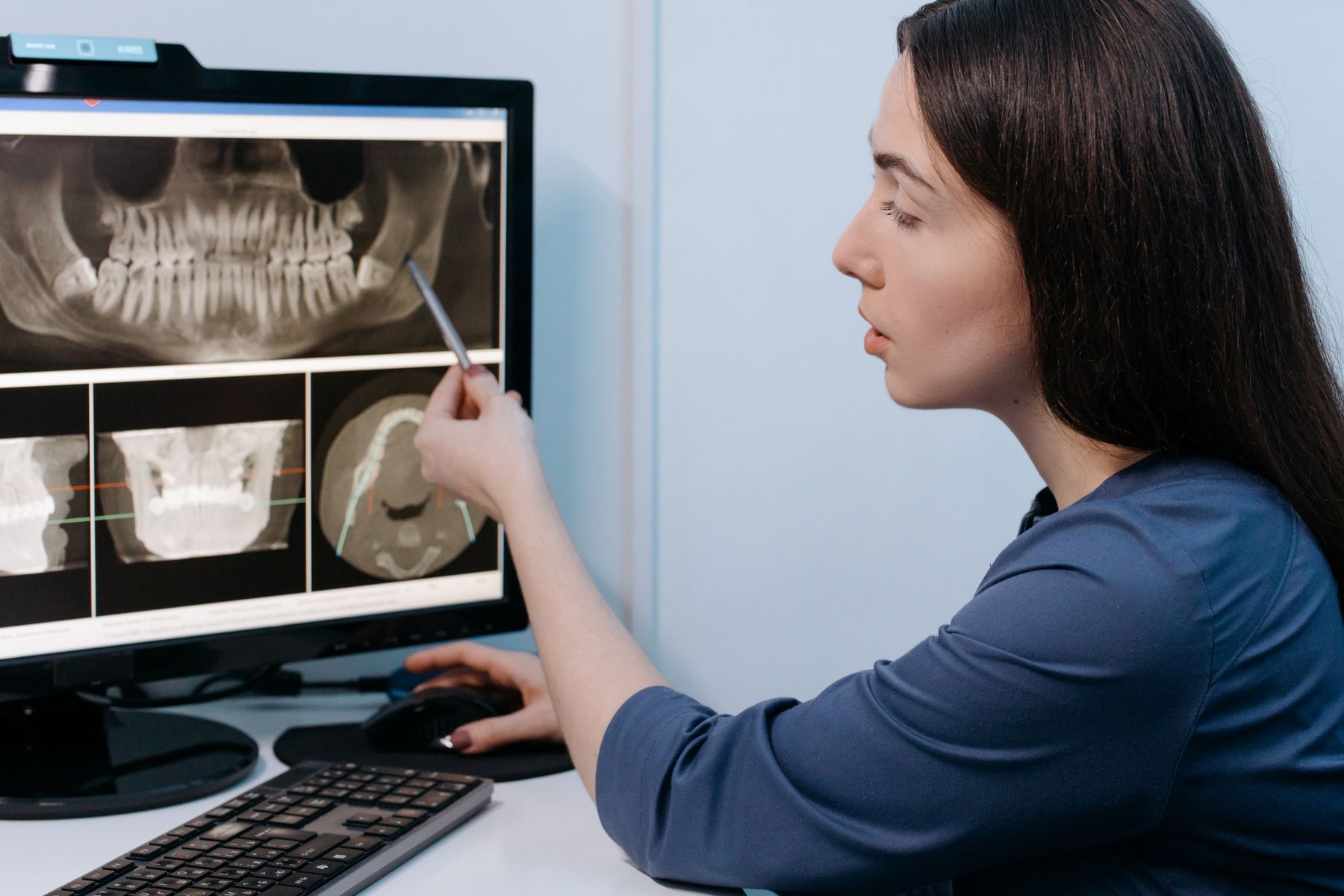 Dental professional reviewing digital imaging for implant treatment planning