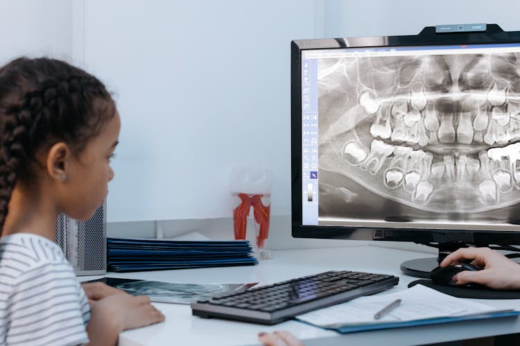 Little Girl Looking At Xray Image At The Computer Screen