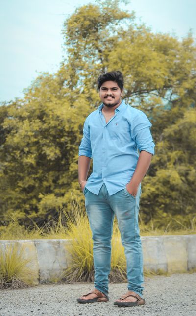 Smiling South Asian man in casual attire outdoors