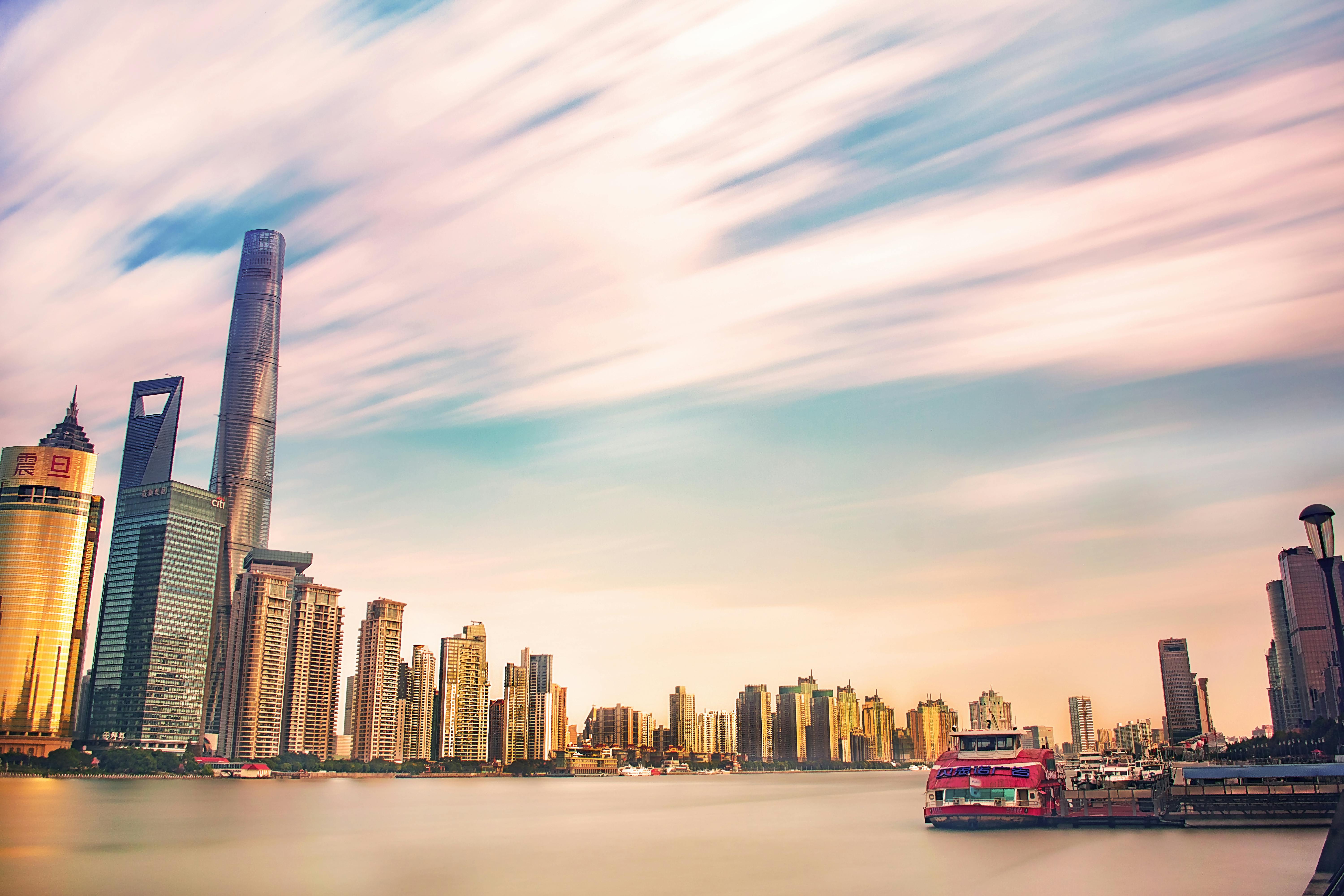 high rise buildings near body of water during golden hour