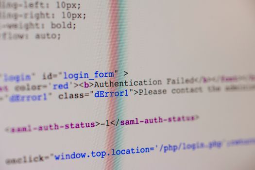 Close-up of HTML and PHP code on screen showing error message and login form data.