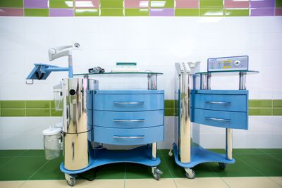 Two modern dental equipment carts in a sterile clinic environment