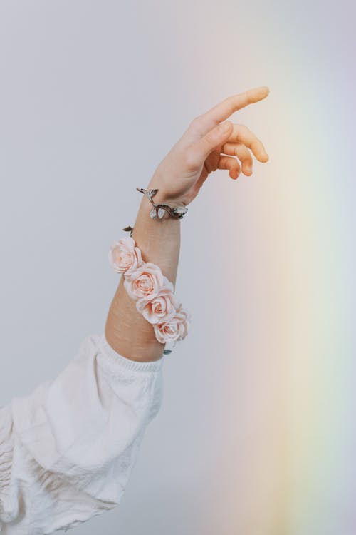 Crop hand of stylish lady in feminine blouse and bracelet