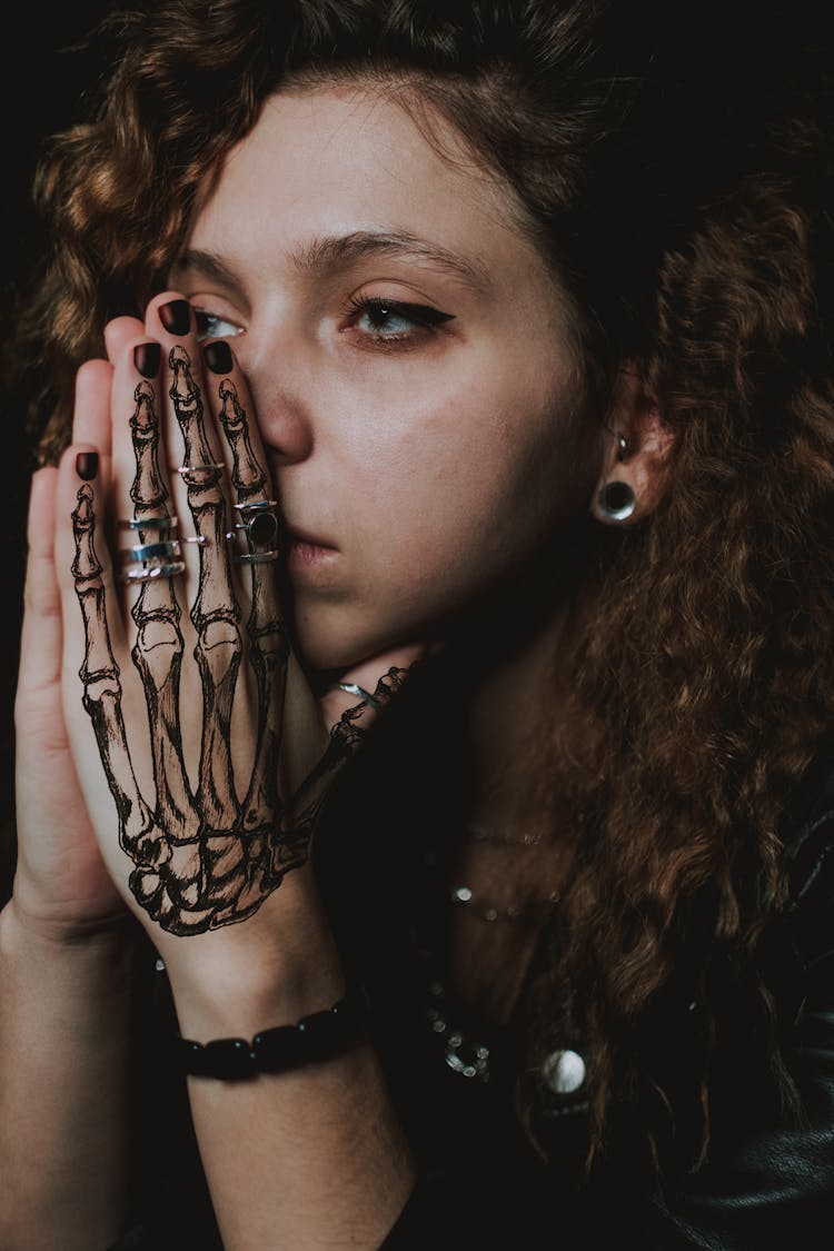 Thoughtful Young Tattooed Lady Praying And Looking Away