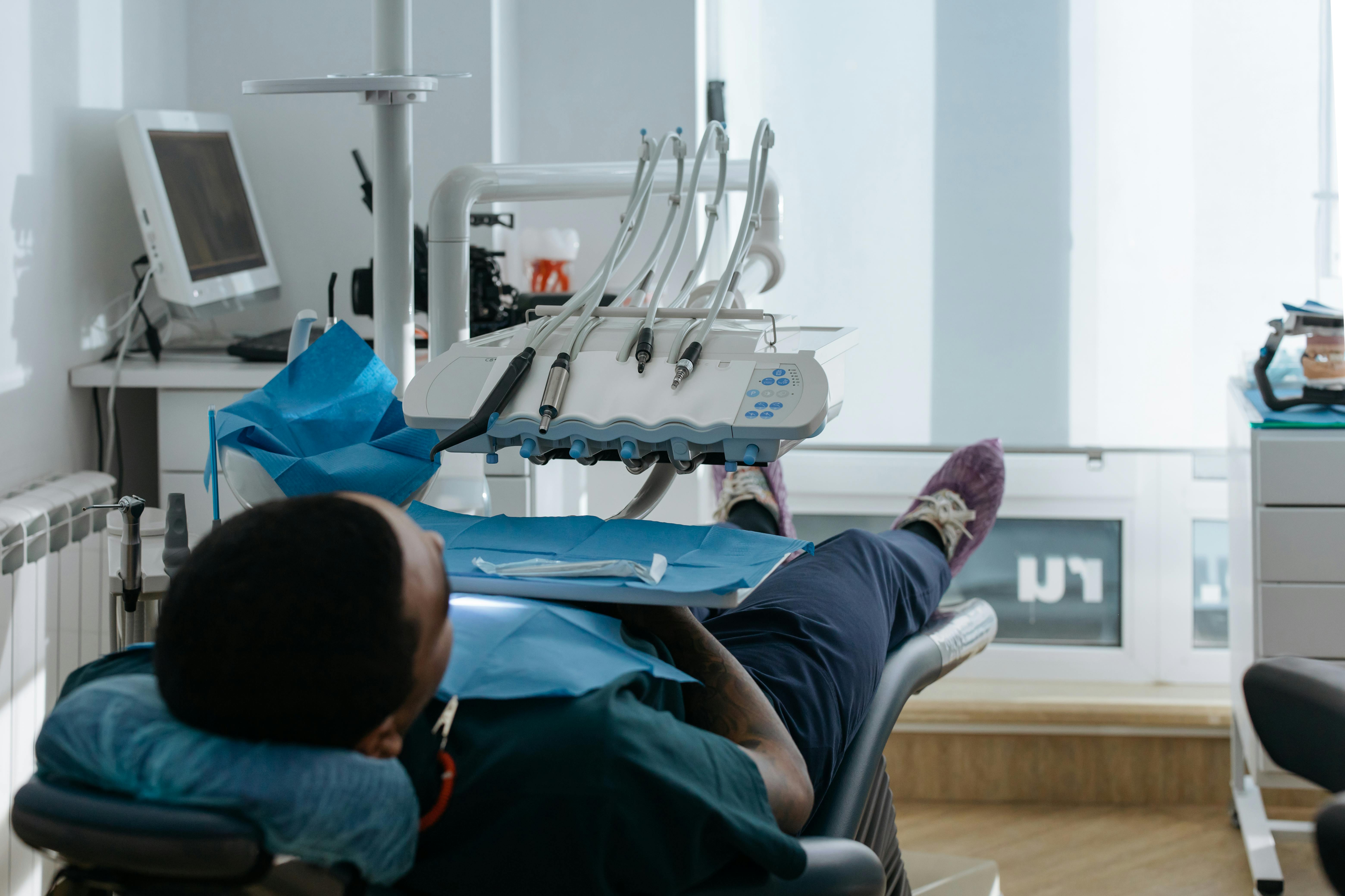 a person lying on a dental chair