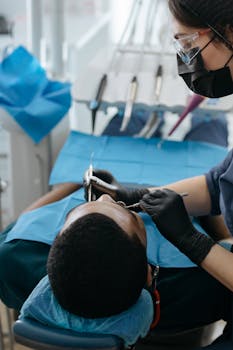 A dentist performs a checkup on a patient in a dental clinic, focusing on oral health care.
