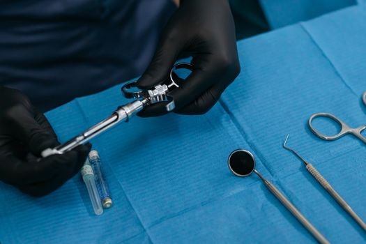 Close-Up Shot of a Dentist Holding a Dental Syringe
