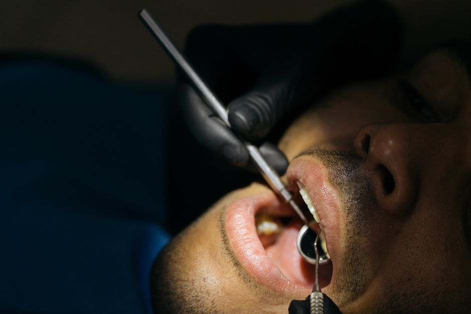 dental professional examining gum tissue - does insurance cover periodontal treatment dental professional examining gum tissue - does insurance cover periodontal treatment