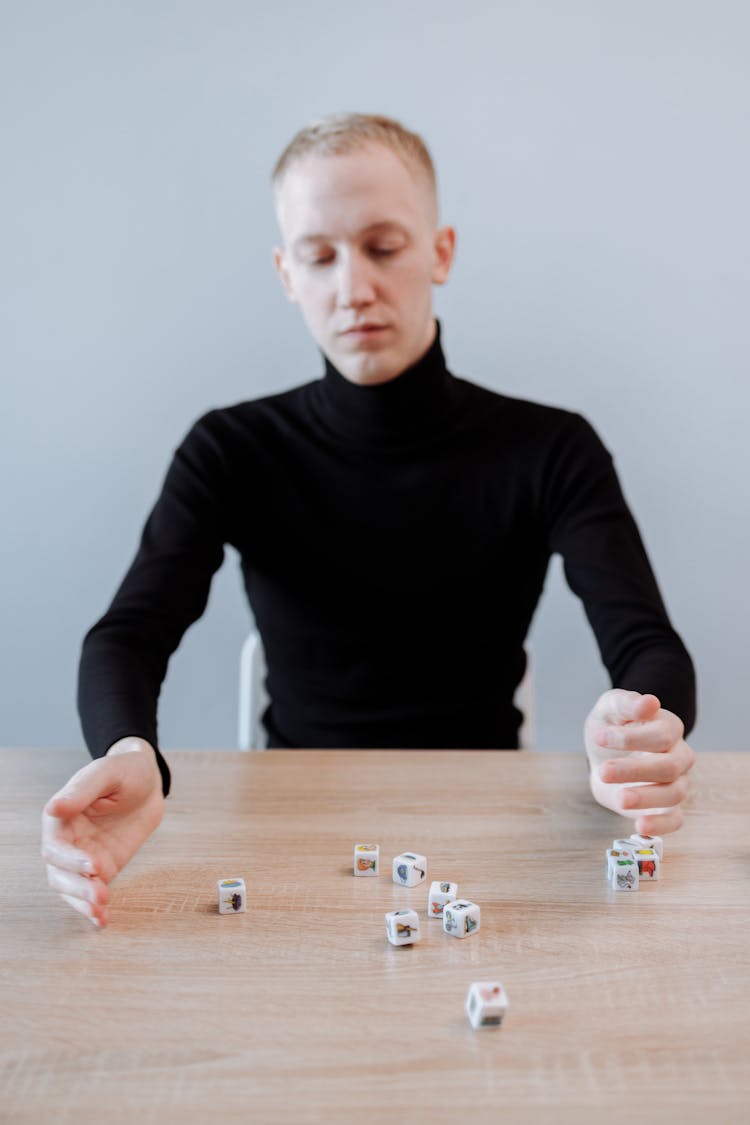 Man In Black Sweater Playing With Dices