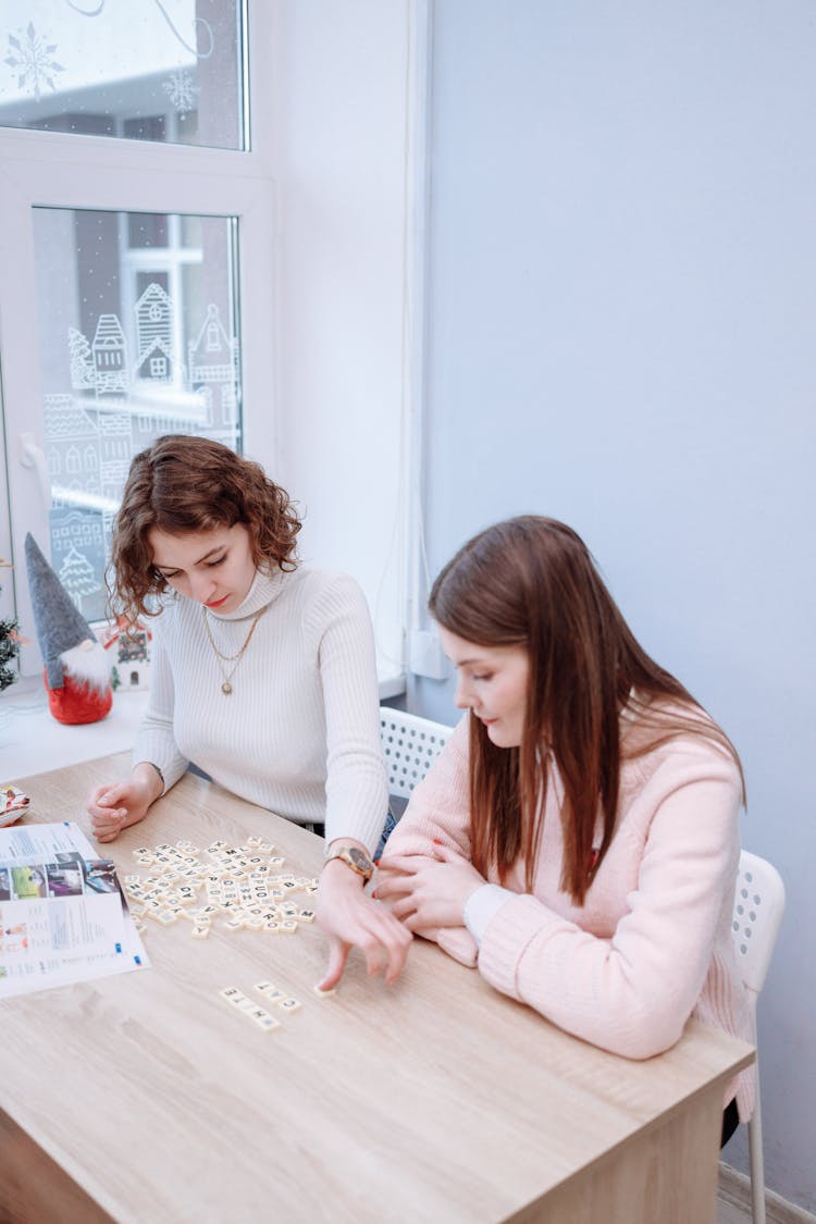 Women Playing With Scrabble Tiles