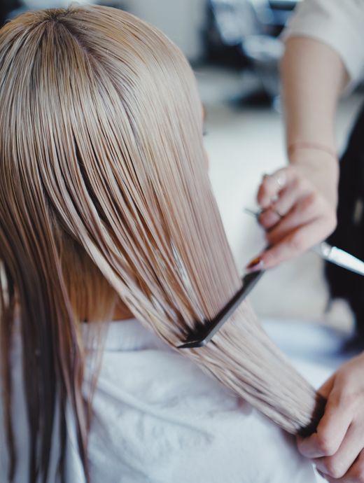 Long straight hair being combed through after a treatment