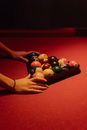 A Woman Holding a Rack with Billiard Balls