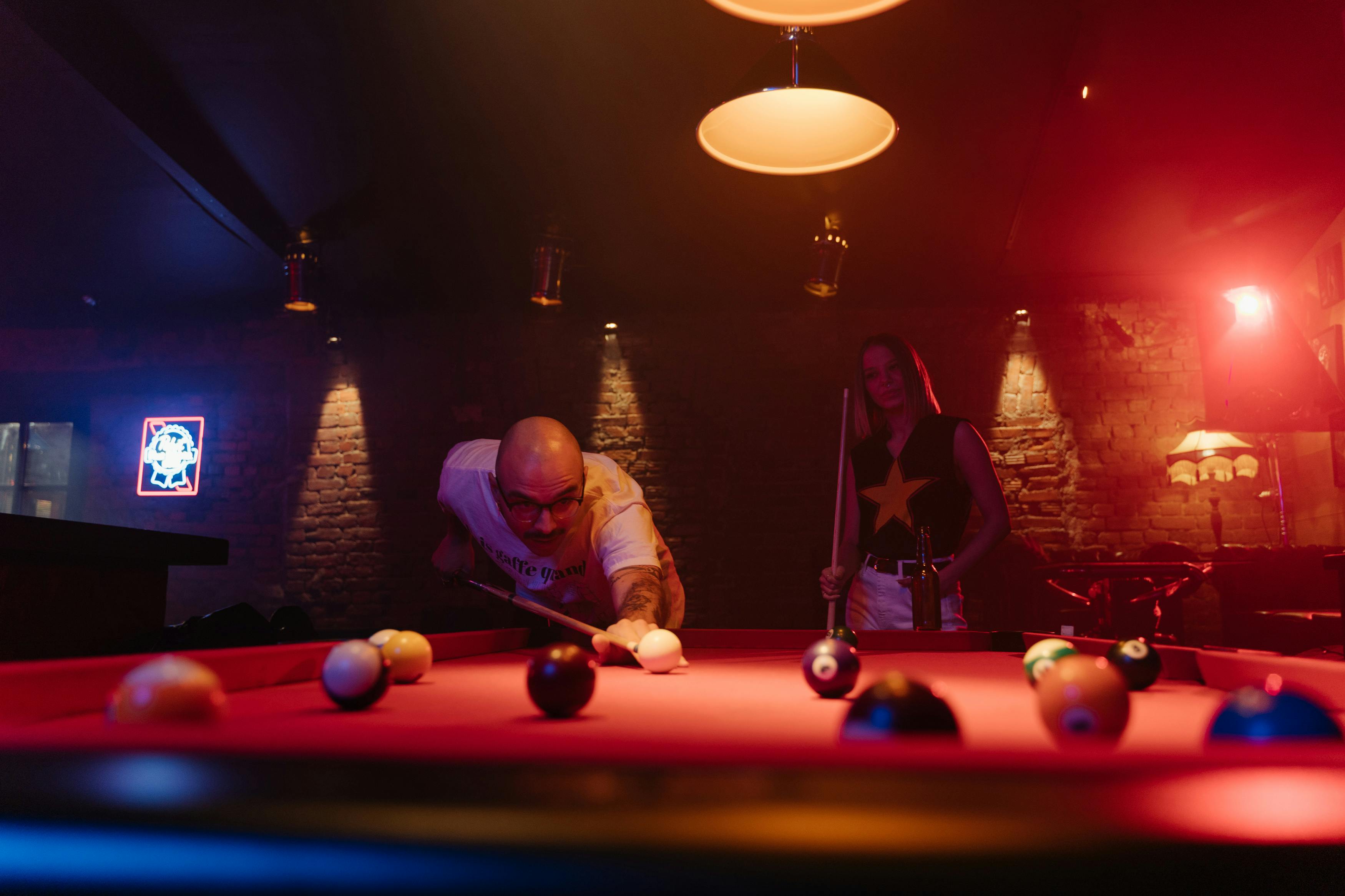 A Man Aiming at the Cue Ball with a Cue Stick · Free Stock Photo