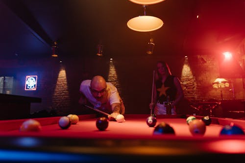 A Man Aiming at the Cue Ball with a Cue Stick