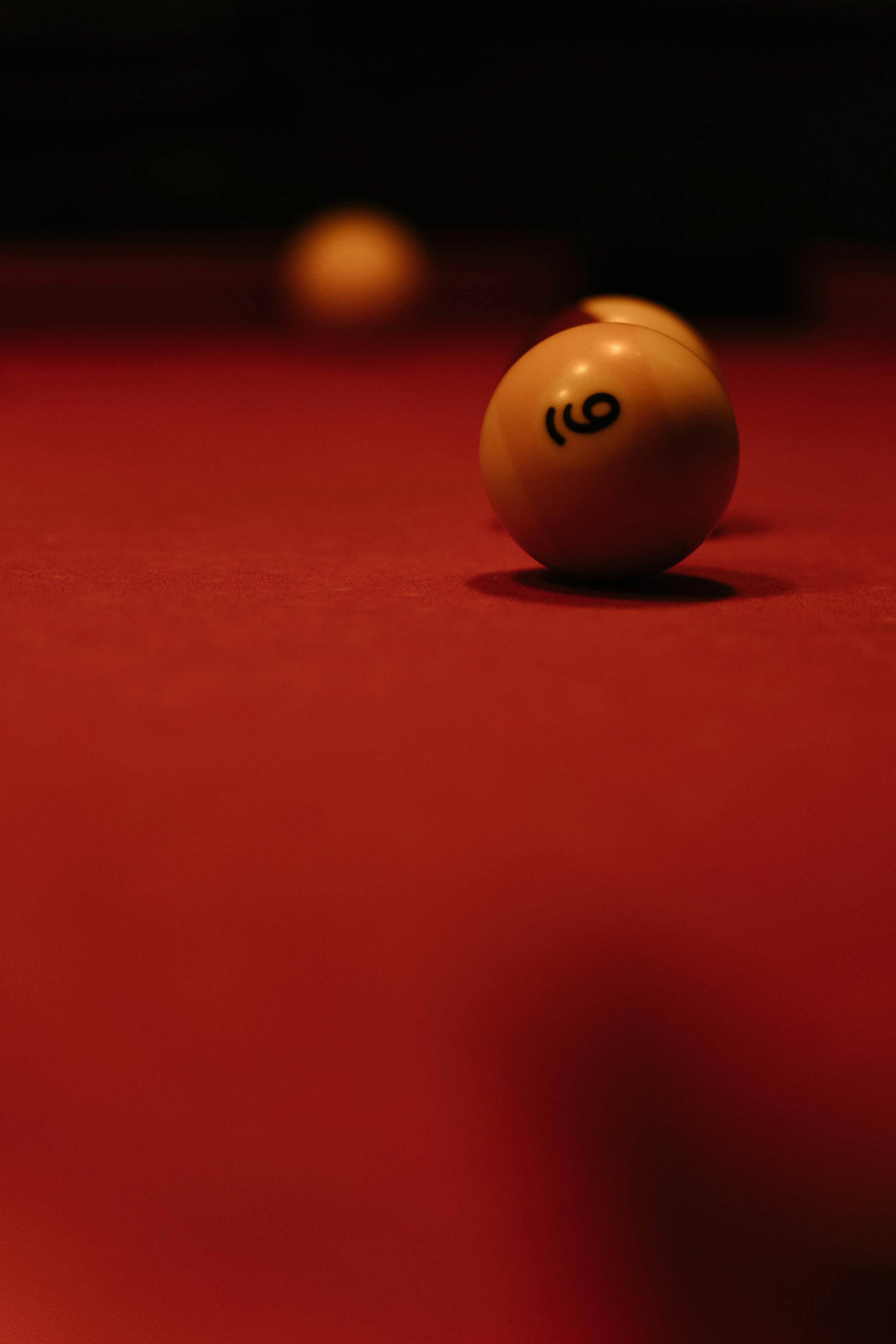 billiard balls on red surface