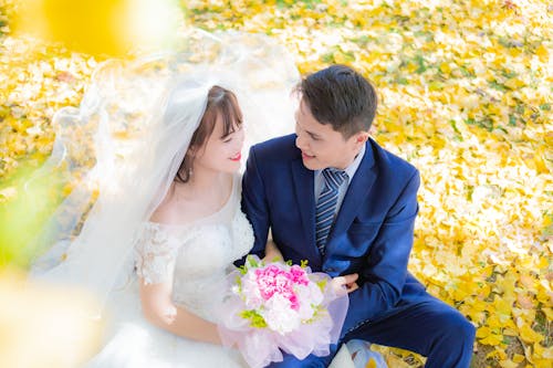 Married Couple Sitting in a Park at Fall