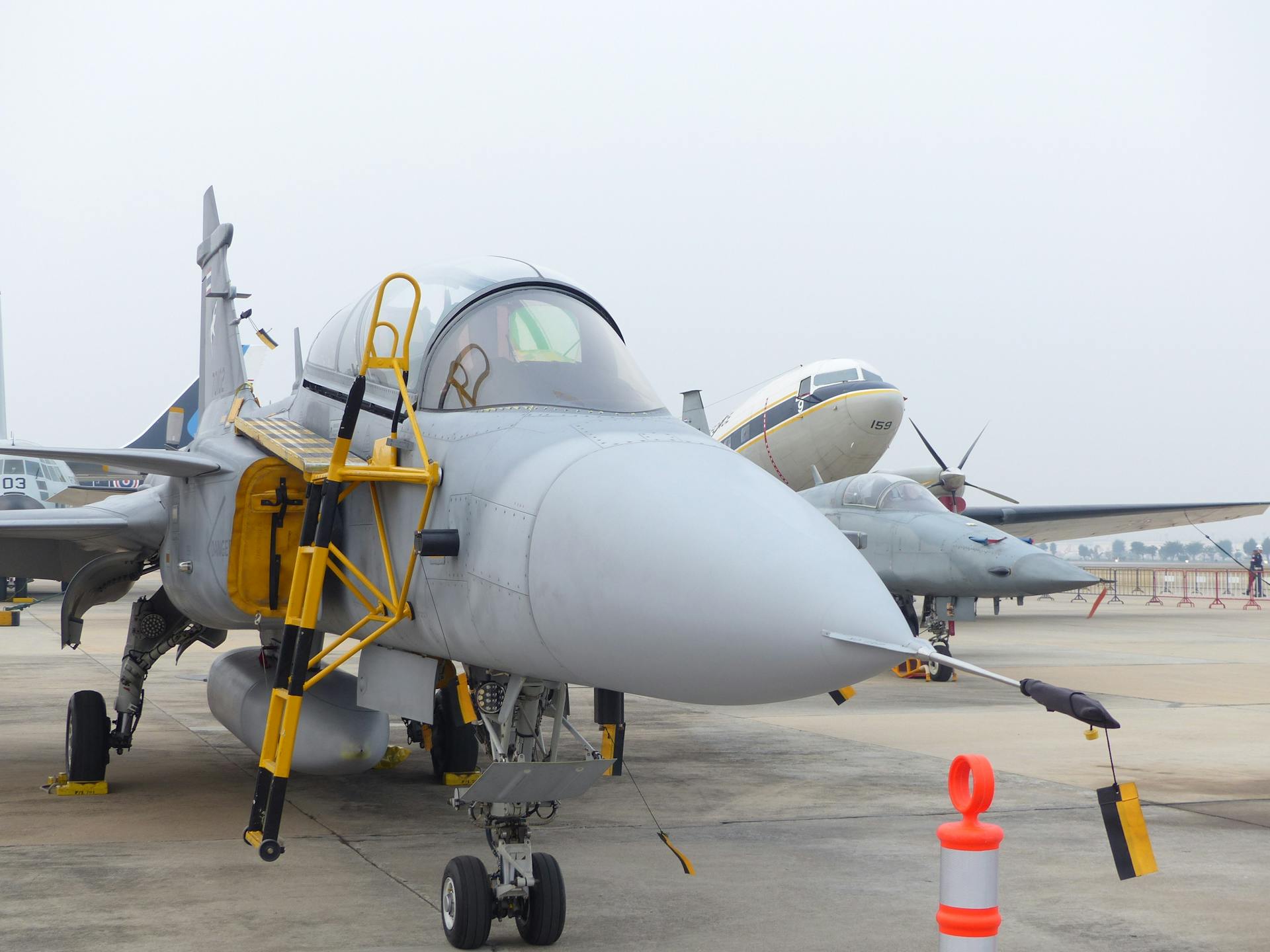 Close-up view of a fighter jet parked at an airport during the day.