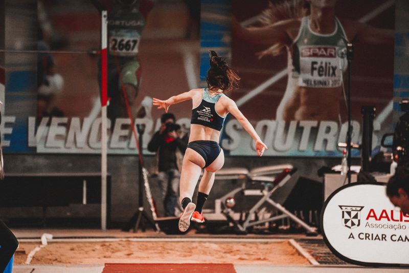 Athlete in mid-air during a long jump