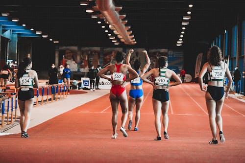 Free Group of Athletes Standing in Line on a Running Track Stock Photo