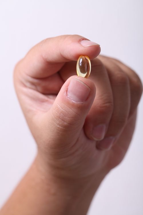 Free A hand gently holding a capsule, symbolizing healthcare and medicine. Stock Photo