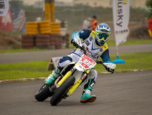 Free Dynamic motocross action with rider taking sharp turn on dirt track. Stock Photo
