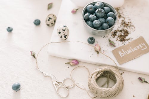 Blueberries In A Bowl Beside Art Materials