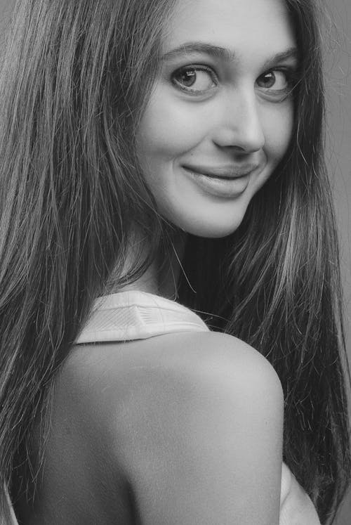 Grayscale Photo of Woman Smiling