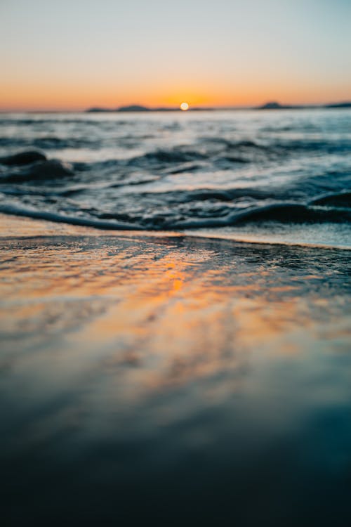 Ocean Waves Crashing on Shore during Sunset