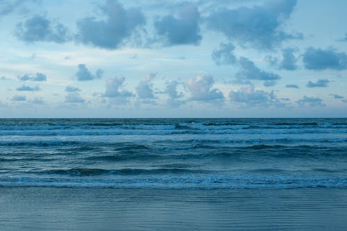 Ocean Waves Under Cloudy Sky