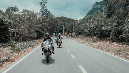 People Riding Motorcycles on the Road