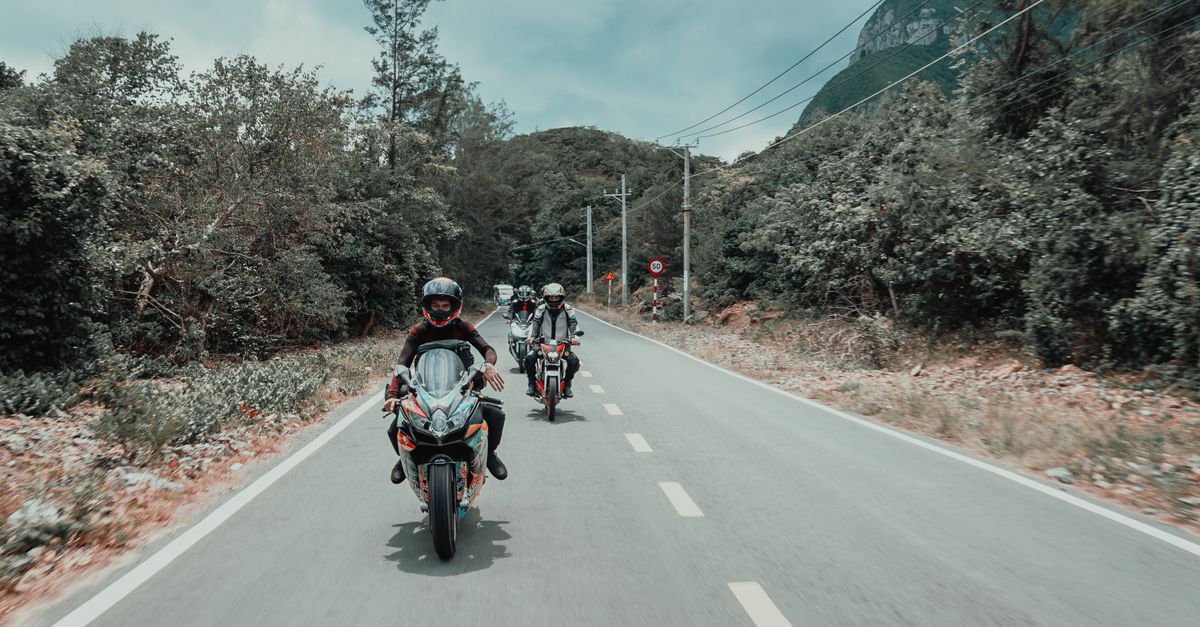 Group of motorcyclists riding on a scenic road in Ba Ria - Vung Tau, Vietnam.