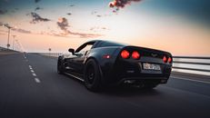 Black Porsche 911 on Road during Sunset