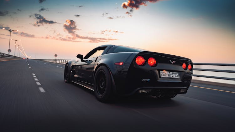 Black Corvette Driving On The Road