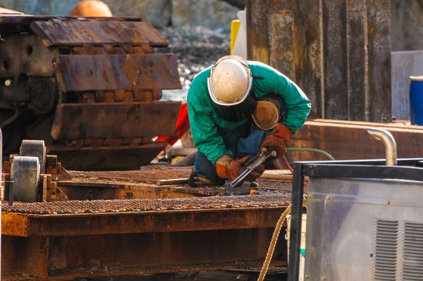 Welder performing ultrasonic testing on pipeline weld
