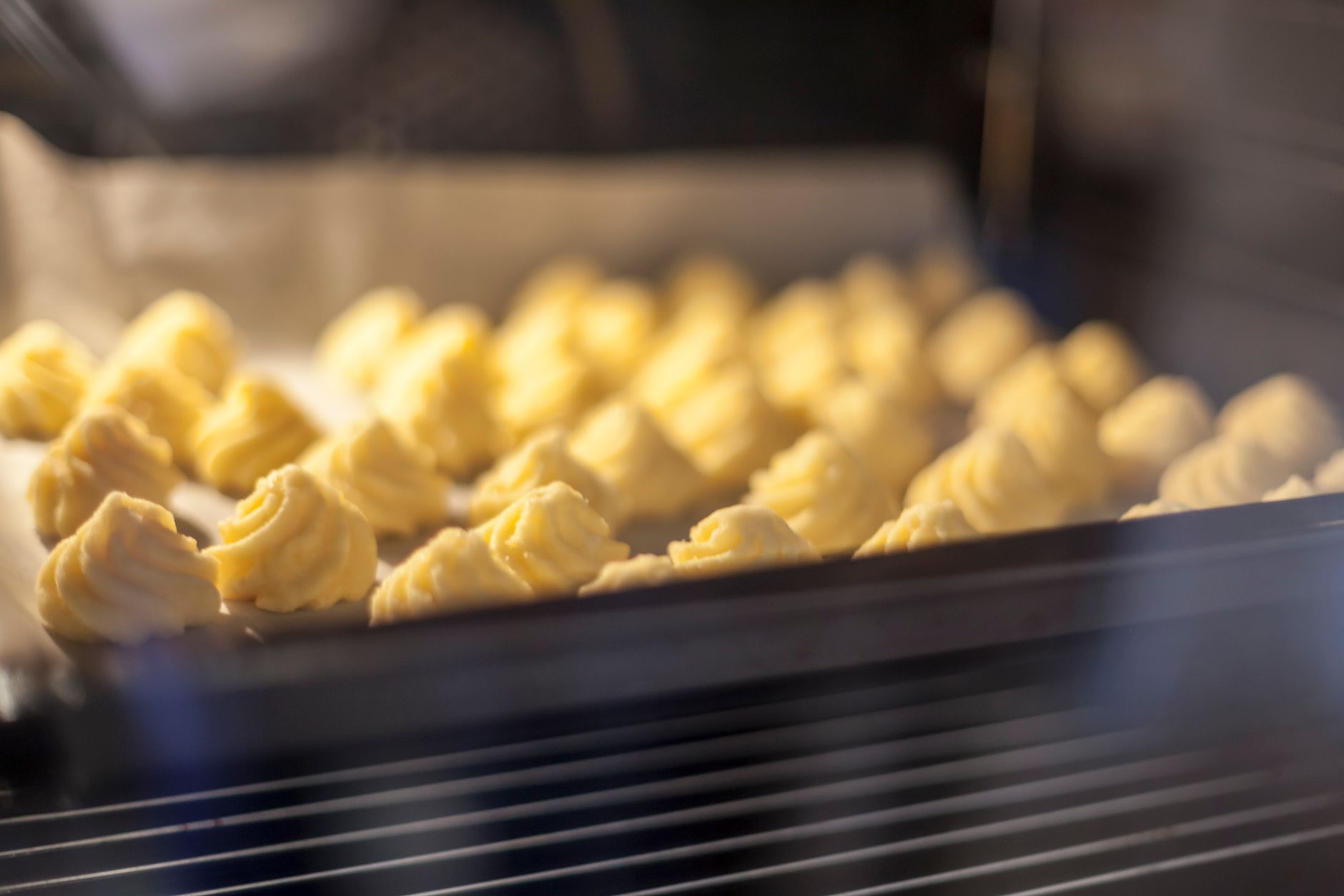 Close-up of baking soda being applied to oven interior for cleaning