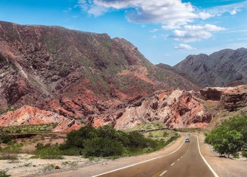 A picturesque drive through vibrant mountains and open sky.