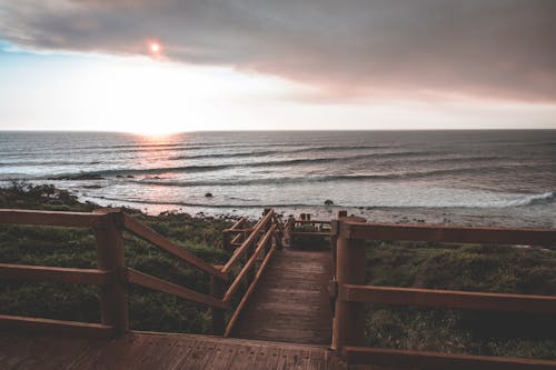 Wooden boardwalk on picturesque evening seashore