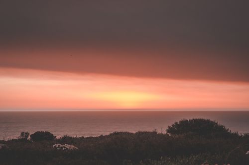 Free Breathtaking scenery of dark pink cloudy sunset sky over endless majestic sea in evening nature Stock Photo