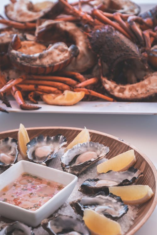 Tasty grilled lobsters and fresh oysters served on table in restaurant