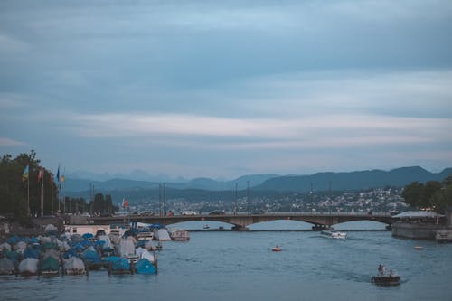 Old bridge over river with boats