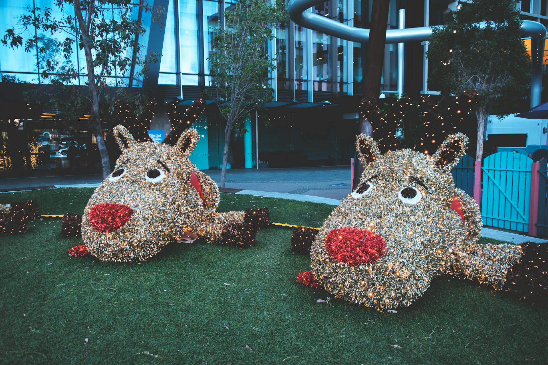 Giant funny figures of animals placed on green lawn