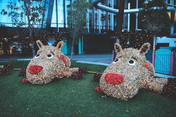 Giant Funny Figures Of Animals Placed On Green Lawn