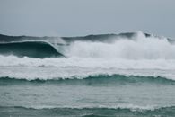 Stormy ocean with splashing waves in cloudy day