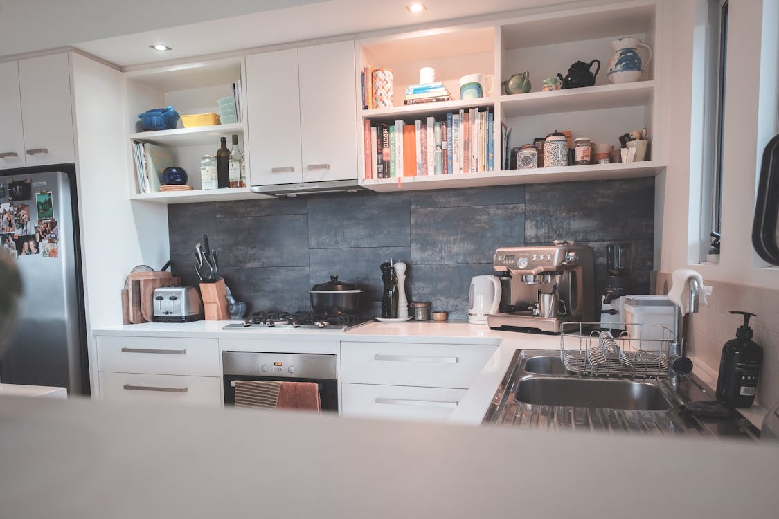 Kitchen with minimalist furniture and modern appliances in flat