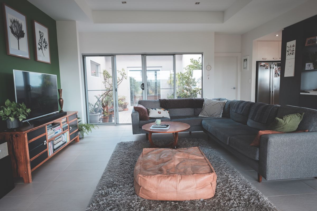 Living room with a grey sectional and sliding patio doors