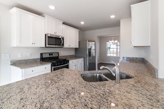 Sleek kitchen interior featuring granite countertops and stainless steel appliances.