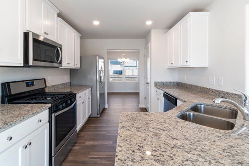 Free Bright and spacious kitchen featuring modern appliances and granite countertops. Stock Photo